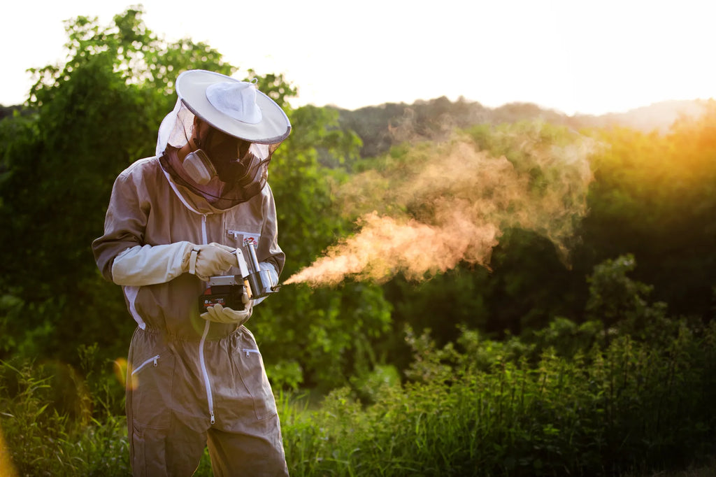 Beekeeper using an InstantVap® cordless oxalic acid vaporiser for varroa treatment